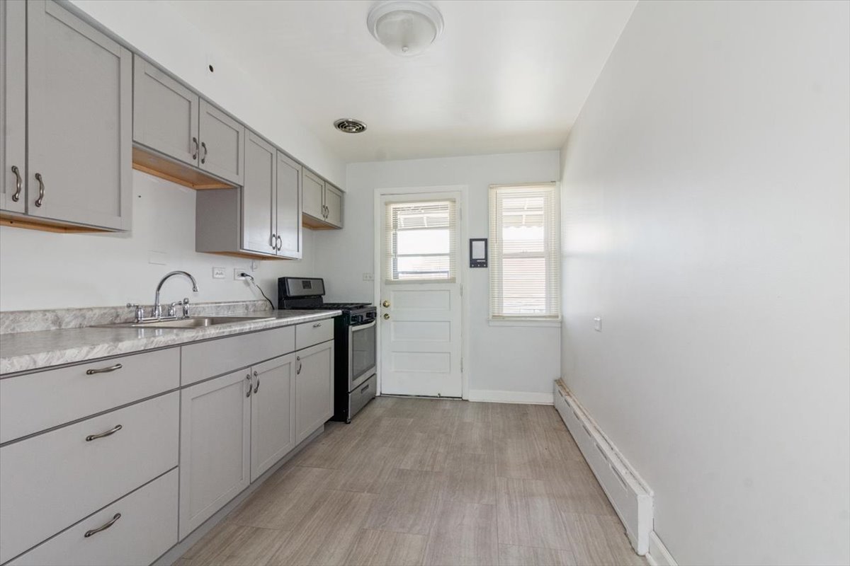1211 Homestead Road La Grange Park, IL 60526 - Photo 10 of 18 a kitchen with sink cabinets and window