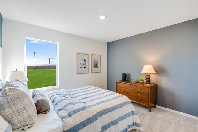 a view of a bedroom with furniture and windows