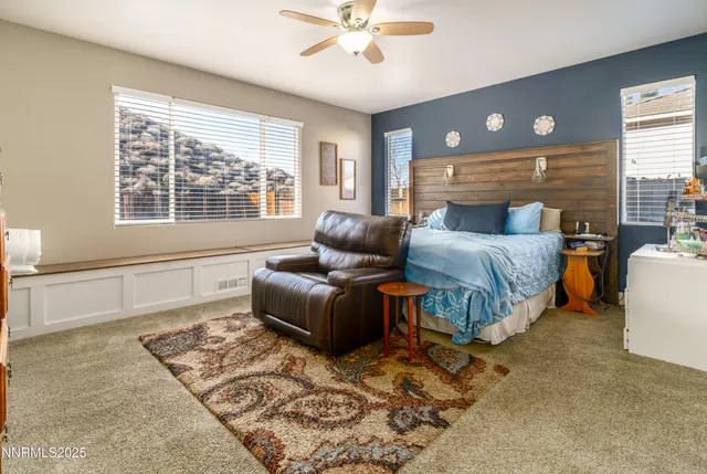 a bedroom with a bed couch and window
