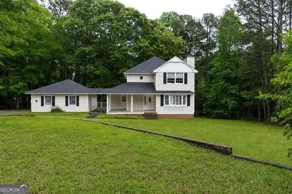 a front view of a house with a garden