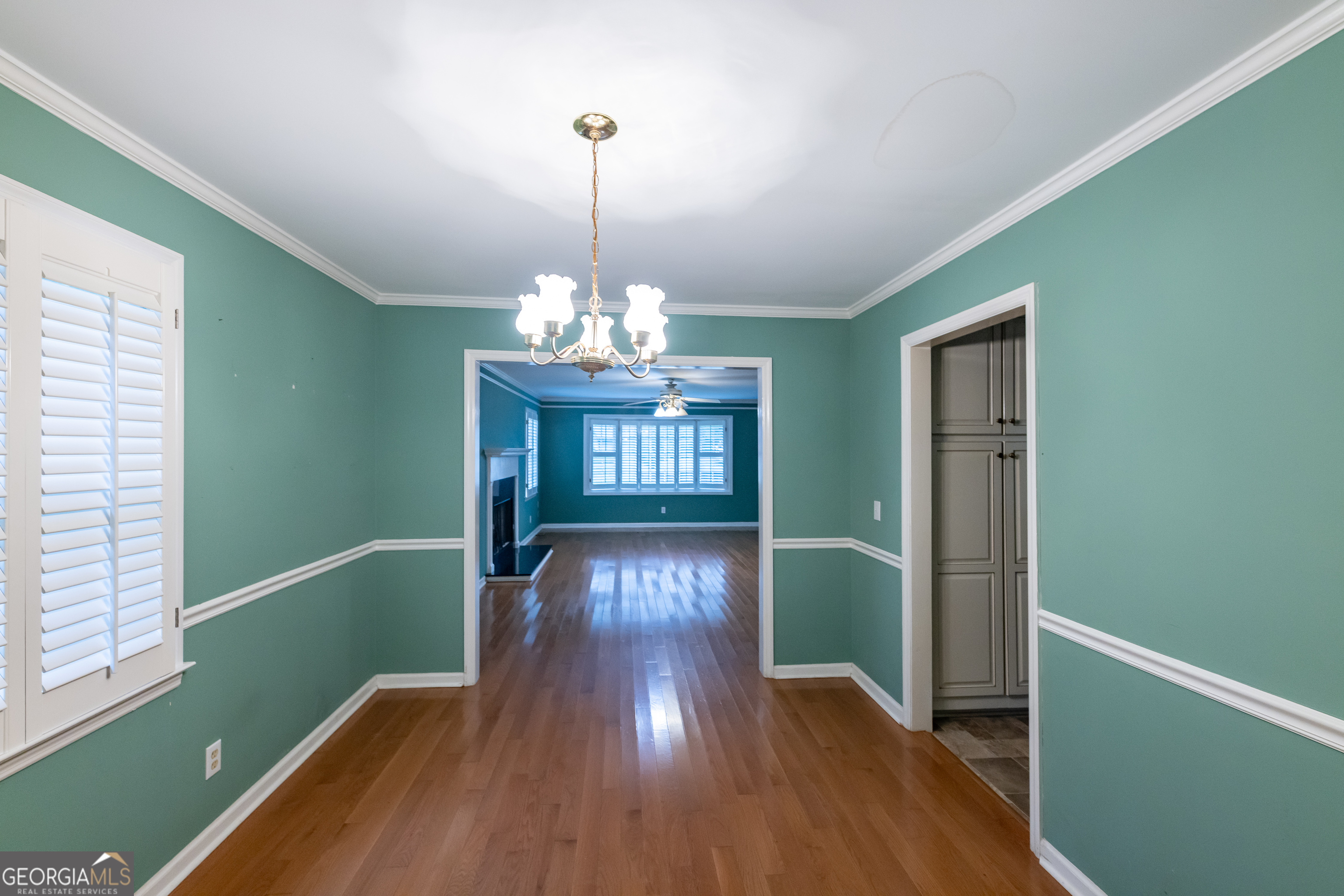 124 David Drive Thomaston, GA 30286 - Photo 12 of 43 a view of a livingroom with wooden floor and chandelier