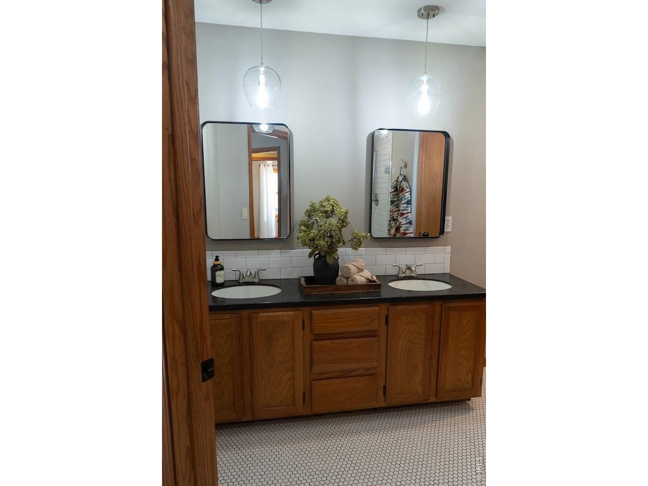 539 South 9th Street Berthoud, CO 80513 - Photo 12 of 37 a bathroom with a double vanity sink and a mirror