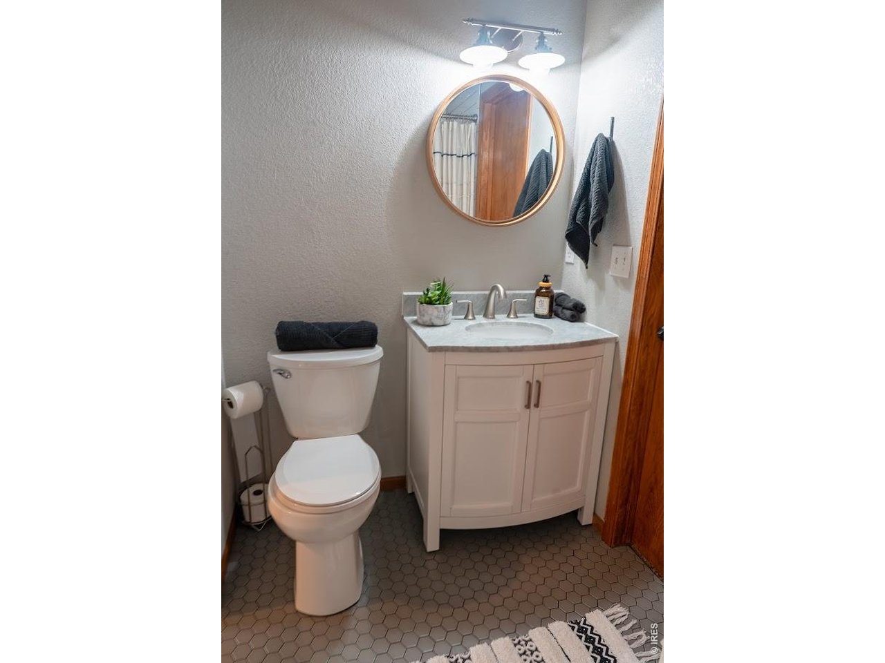 539 South 9th Street Berthoud, CO 80513 - Photo 21 of 37 a bathroom with a toilet a sink and a mirror