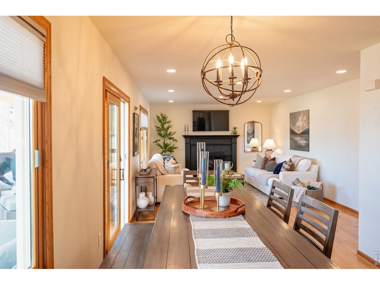 539 South 9th Street Berthoud, CO 80513 - Photo 5 of 37 a living room with furniture a fireplace and a chandelier