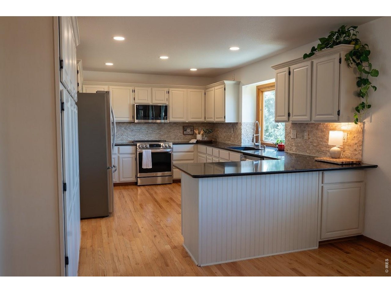 539 South 9th Street Berthoud, CO 80513 - Photo 6 of 37 a kitchen with stainless steel appliances granite countertop a refrigerator sink and cabinets