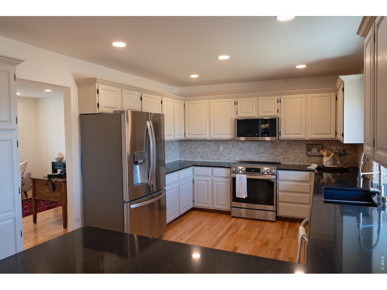 539 South 9th Street Berthoud, CO 80513 - Photo 7 of 37 a kitchen with stainless steel appliances granite countertop a refrigerator and a stove