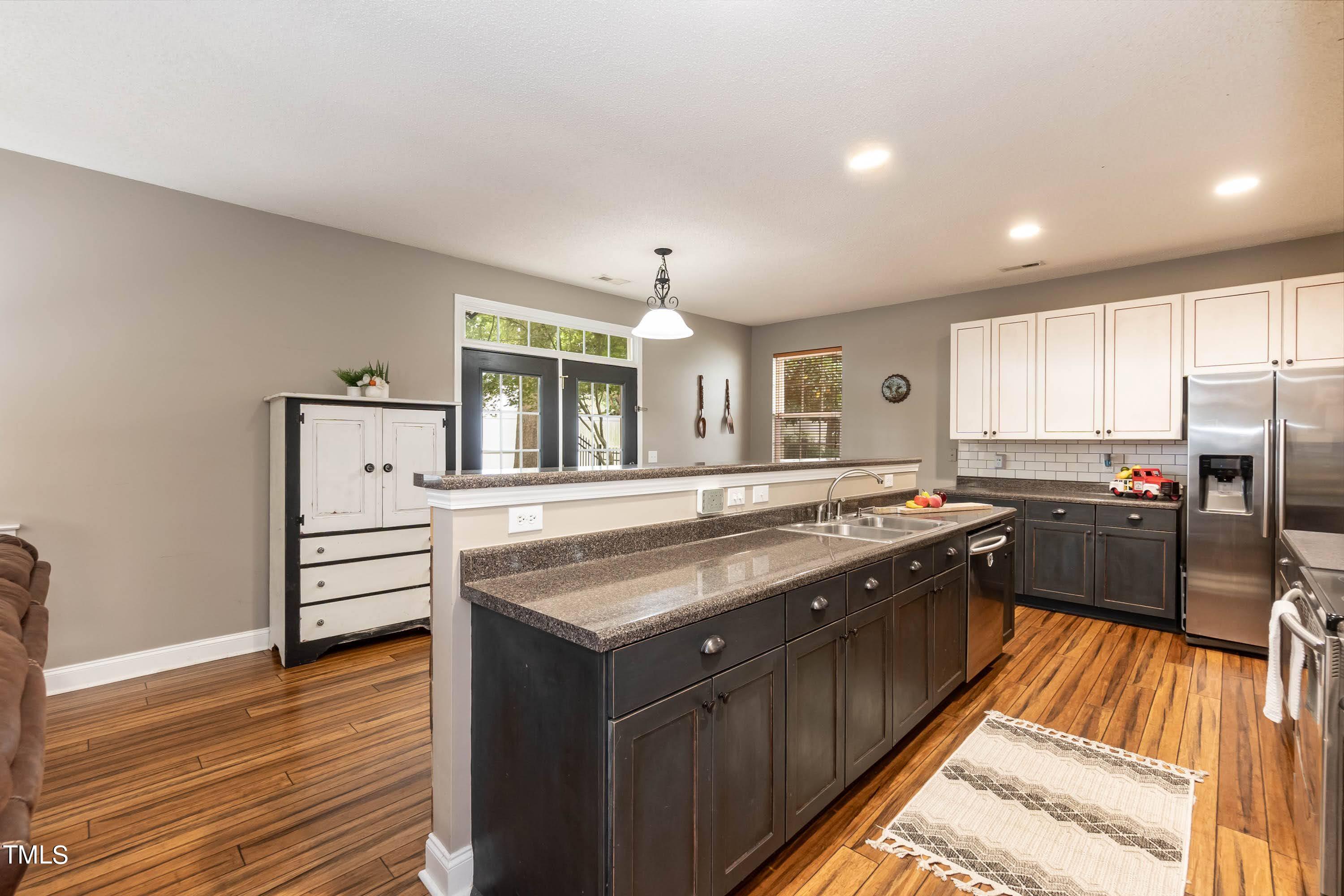 108 Solheim Lane Raleigh, NC 27603 - Photo 15 of 49 a kitchen with stainless steel appliances granite countertop a stove and a sink