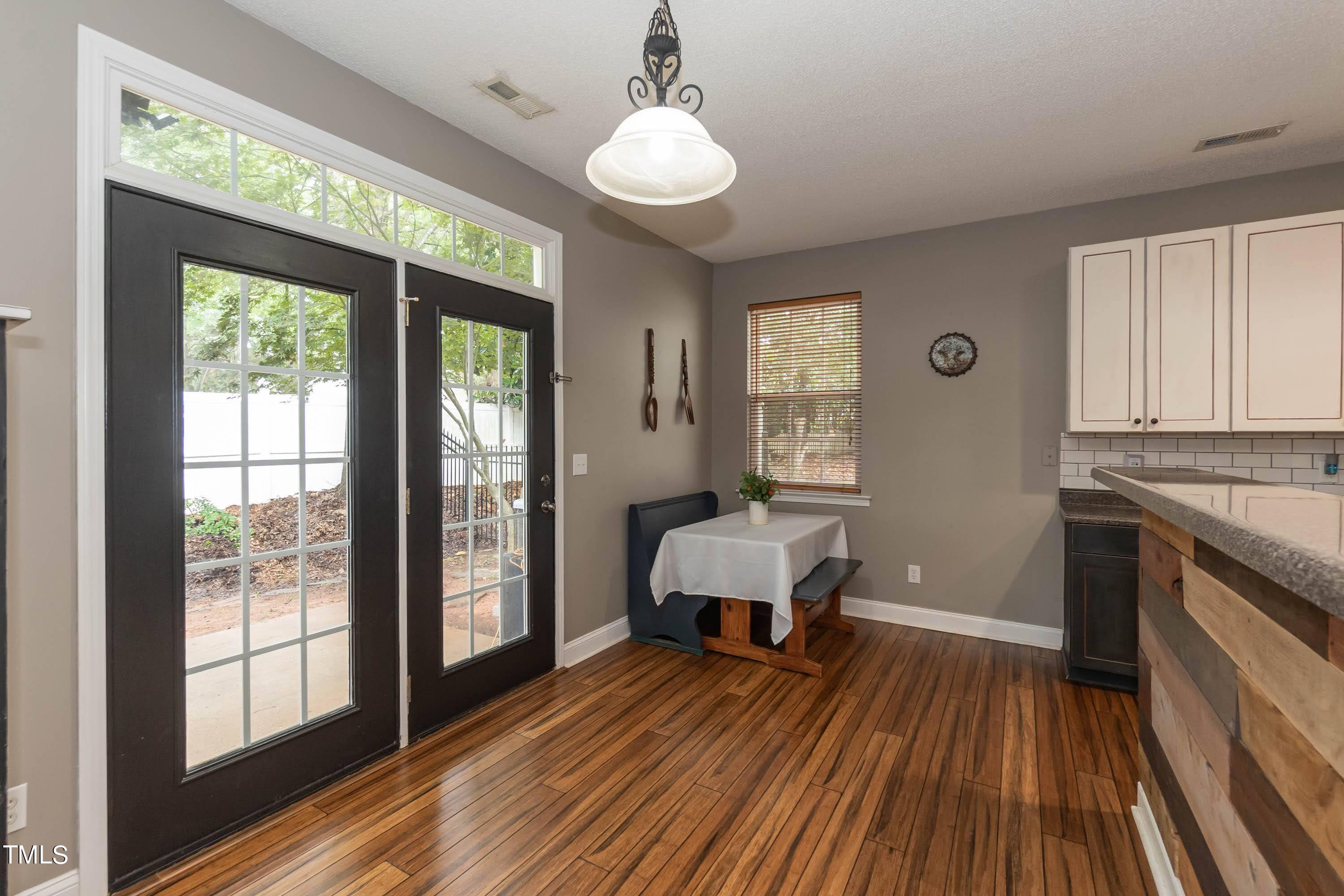 108 Solheim Lane Raleigh, NC 27603 - Photo 18 of 49 a spacious bedroom with a bed and wooden floor