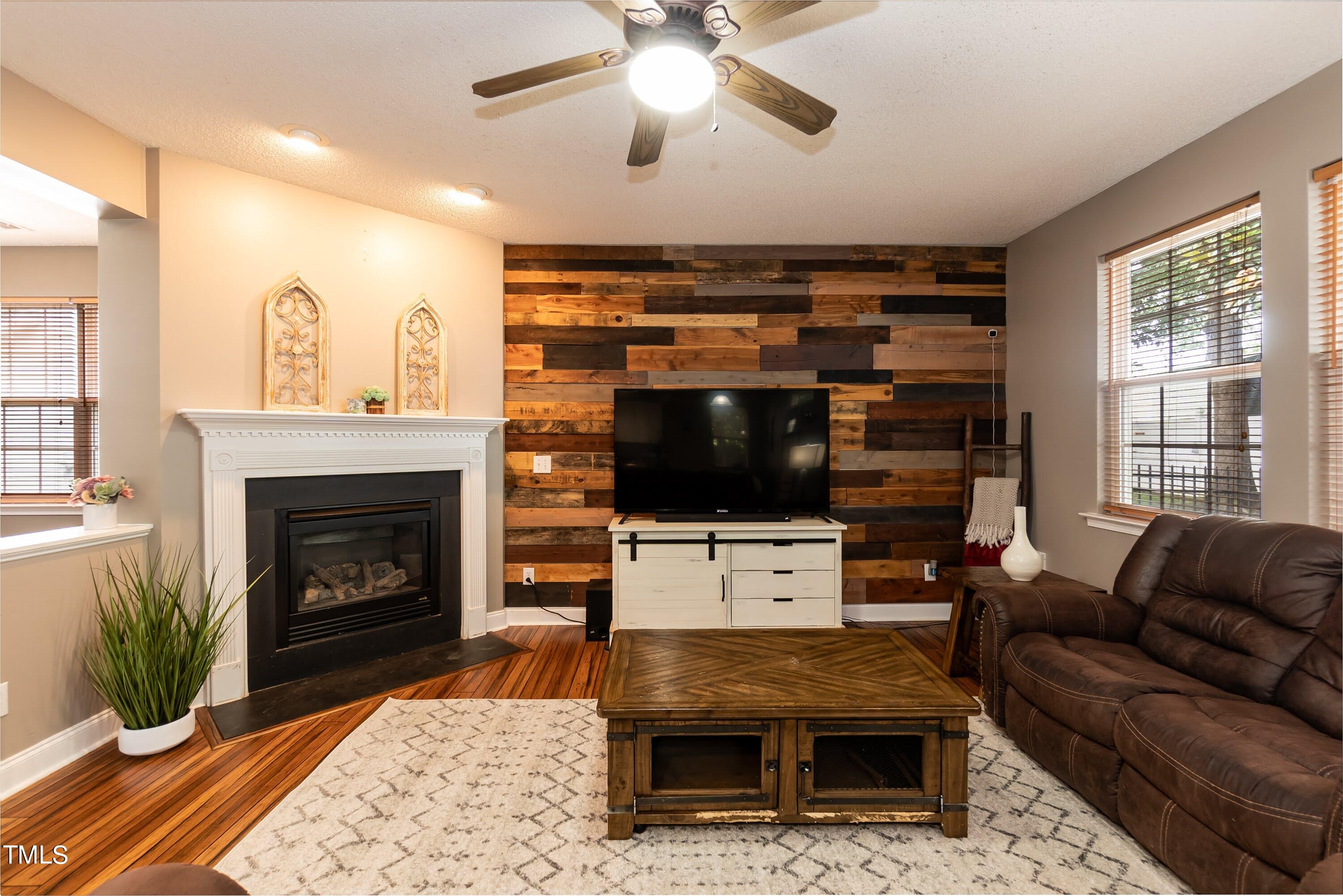 108 Solheim Lane Raleigh, NC 27603 - Photo 20 of 49 a living room with furniture a flat screen tv and a fireplace
