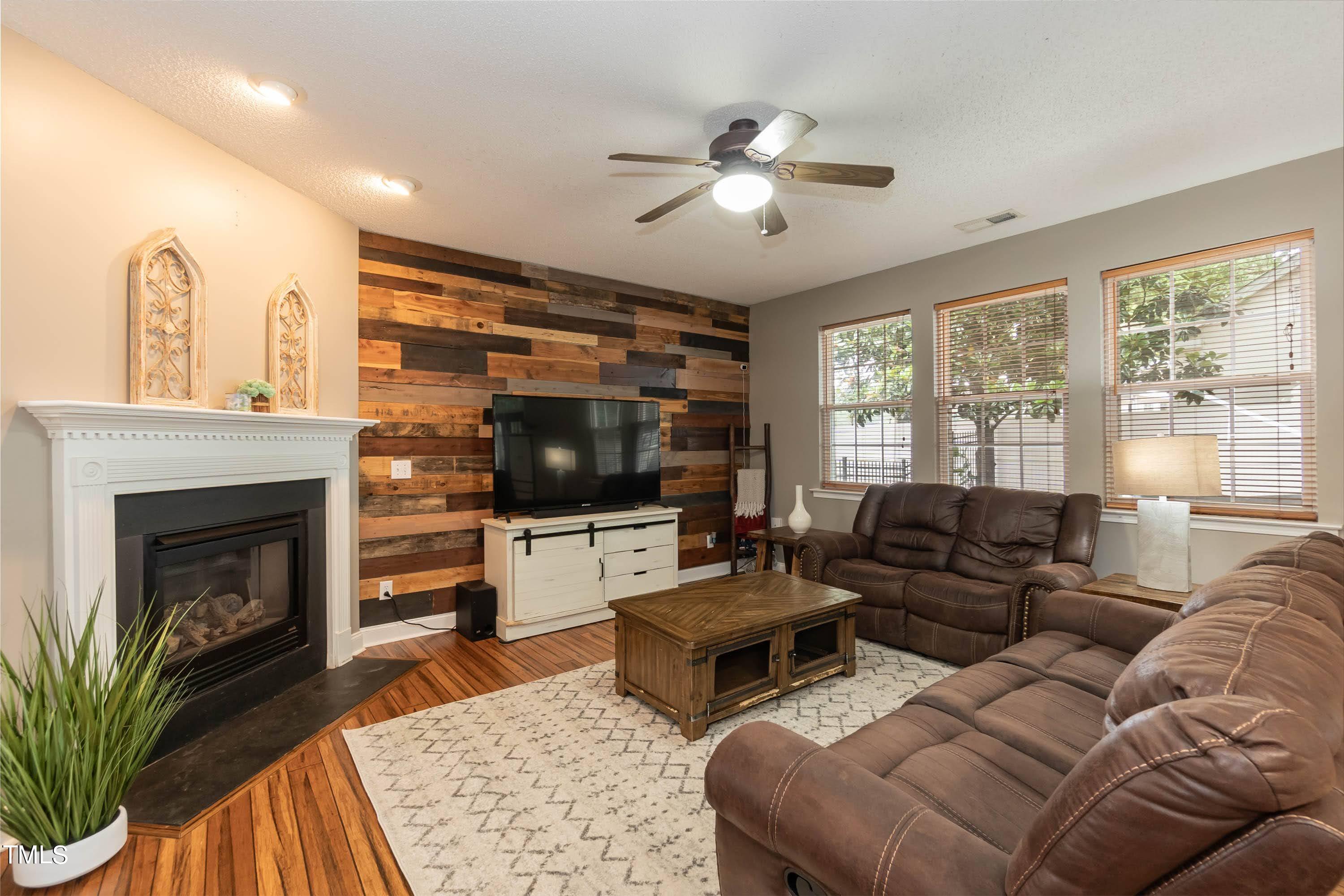 108 Solheim Lane Raleigh, NC 27603 - Photo 21 of 49 a living room with furniture fireplace and flat screen tv