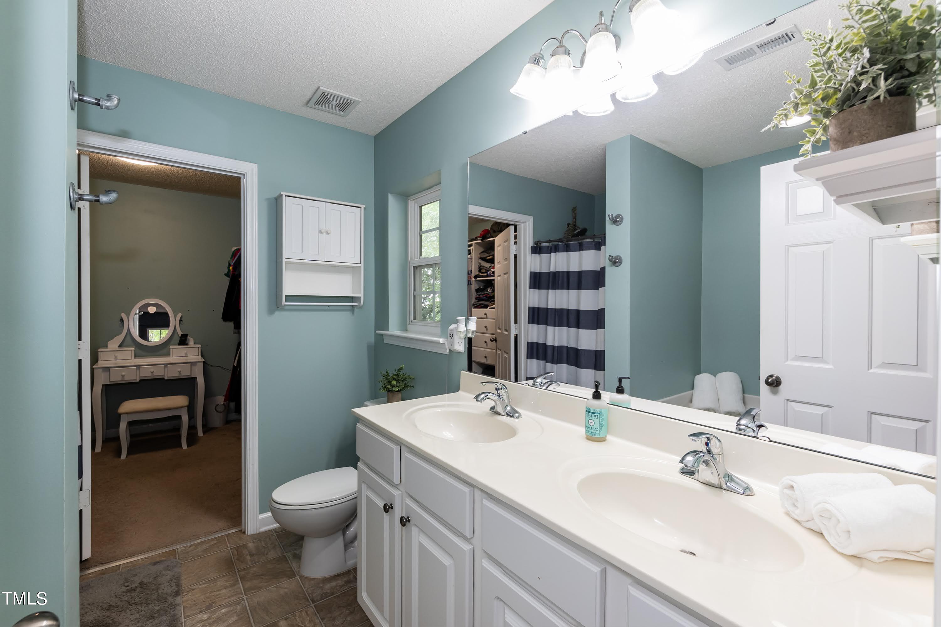 108 Solheim Lane Raleigh, NC 27603 - Photo 25 of 49 a bathroom with a toilet a sink and mirror