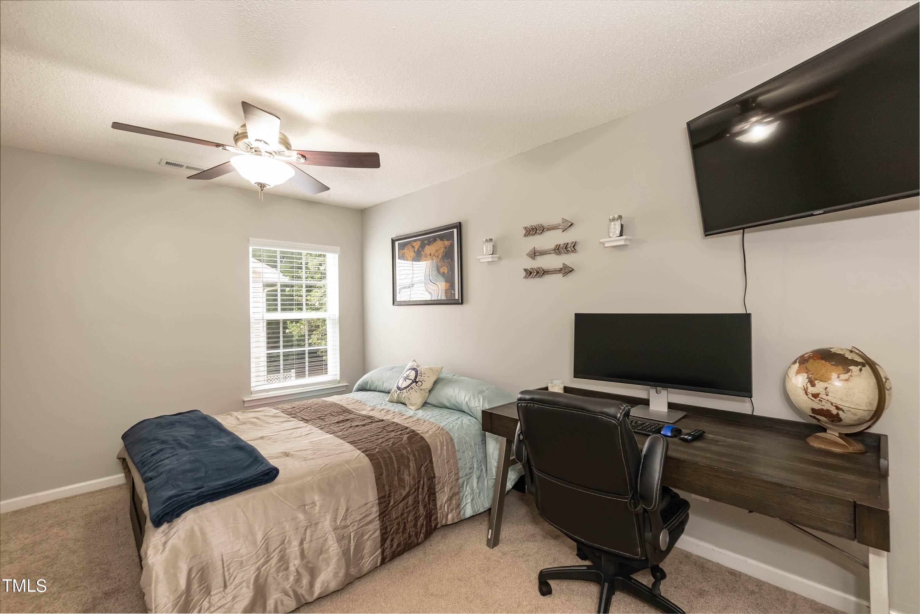 108 Solheim Lane Raleigh, NC 27603 - Photo 29 of 49 a bedroom with a bed tv and a window