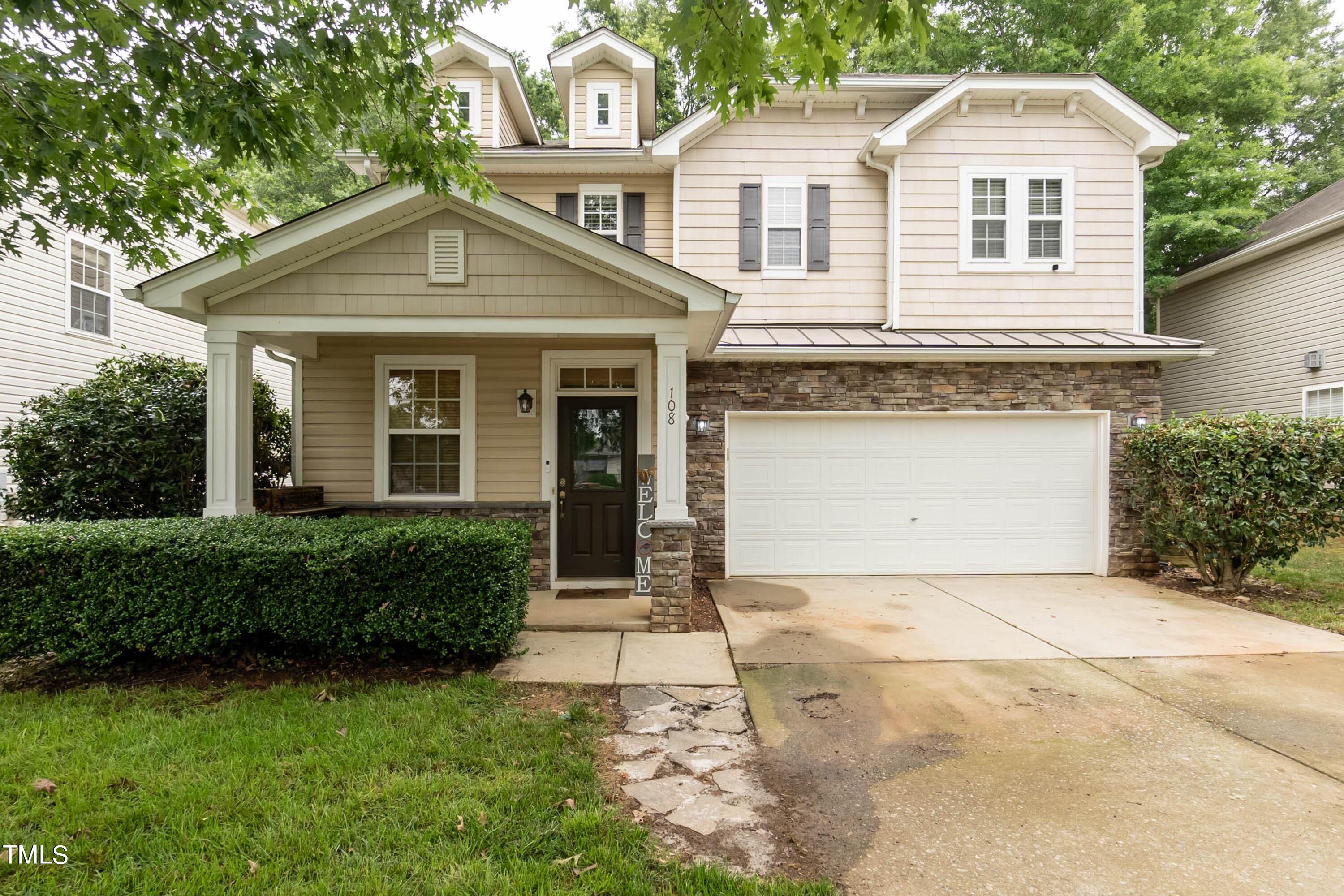 108 Solheim Lane Raleigh, NC 27603 - Photo 3 of 49 a front view of a house with a yard and garage