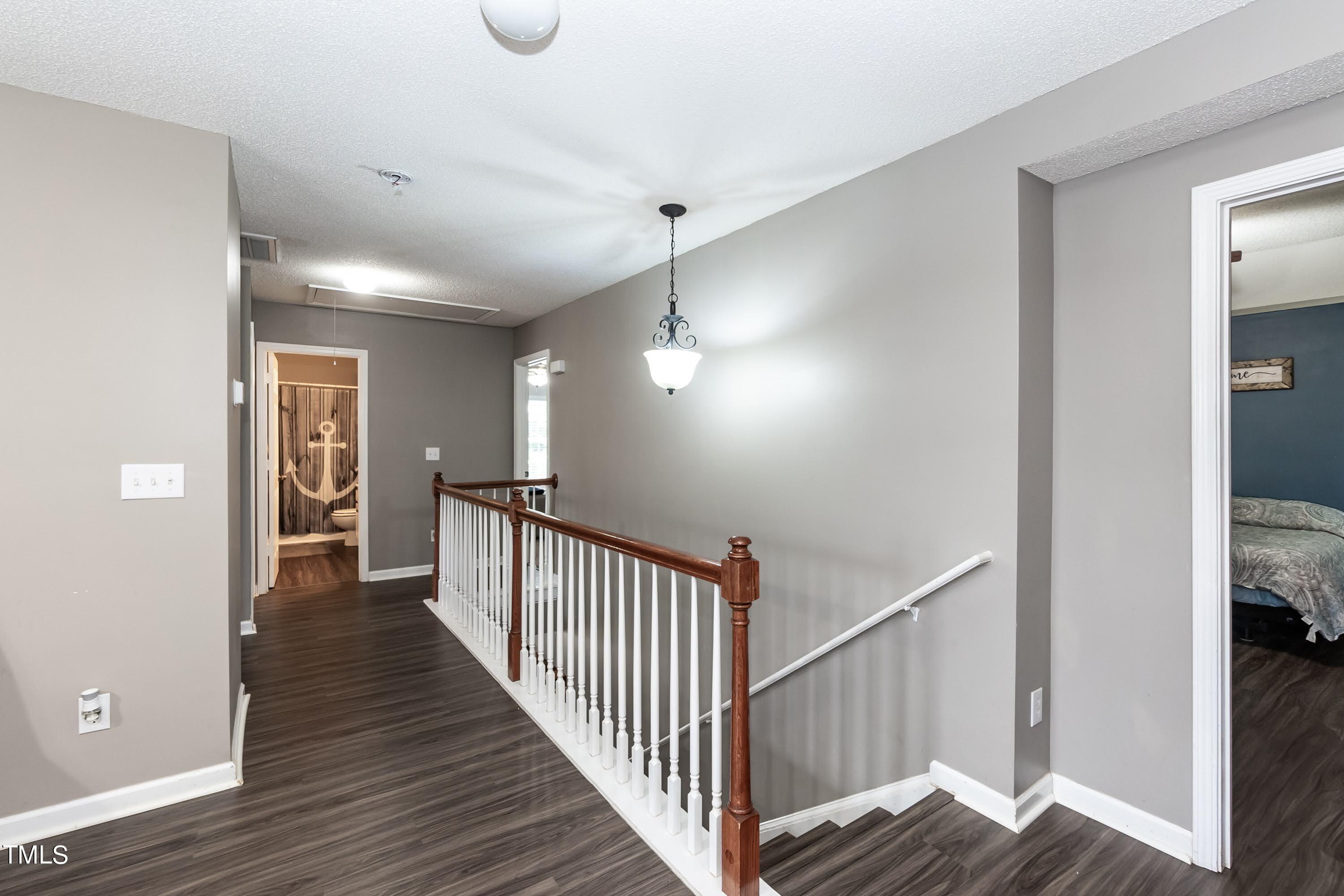108 Solheim Lane Raleigh, NC 27603 - Photo 31 of 49 a view of a hallway with wooden floor