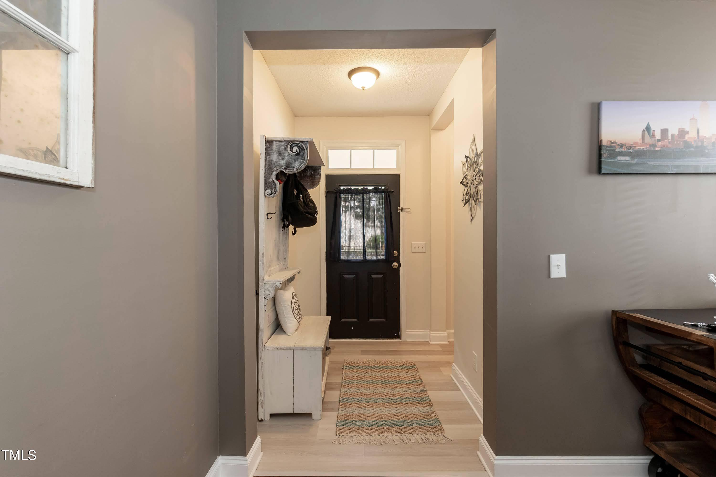 108 Solheim Lane Raleigh, NC 27603 - Photo 10 of 49 a view of a hallway with wooden floor and a workspace