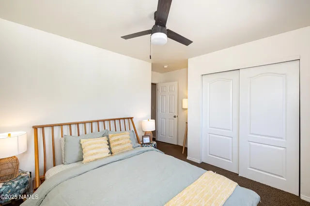 a bedroom with a bed and ceiling fan