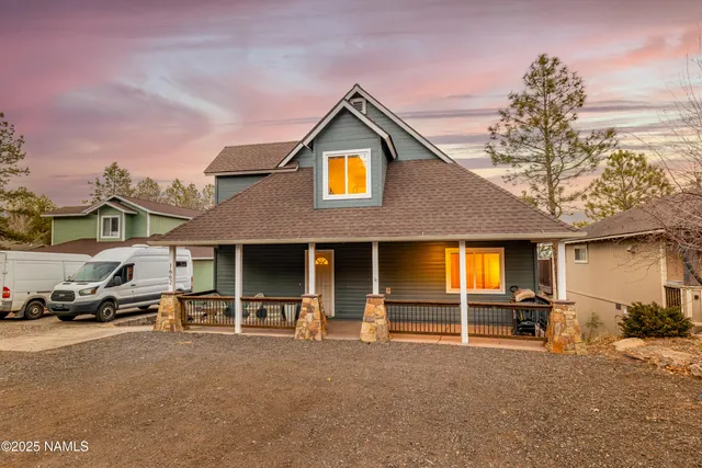 a view of multiple houses with cars parked