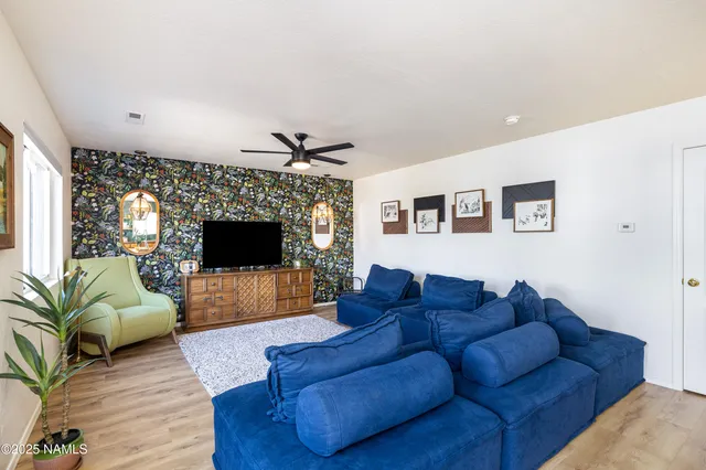 a living room with furniture and a flat screen tv