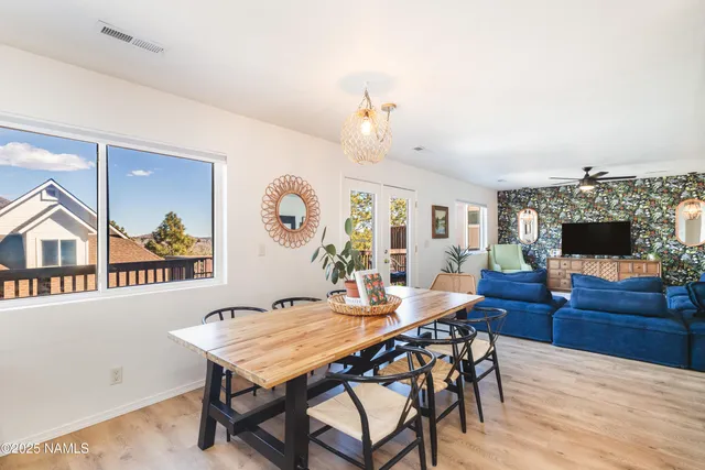 a view of a dining room with furniture and a flat screen tv