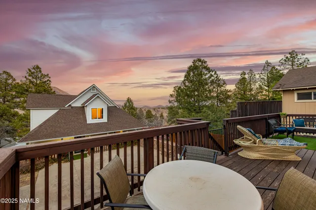 a view of a chairs and table in the balcony