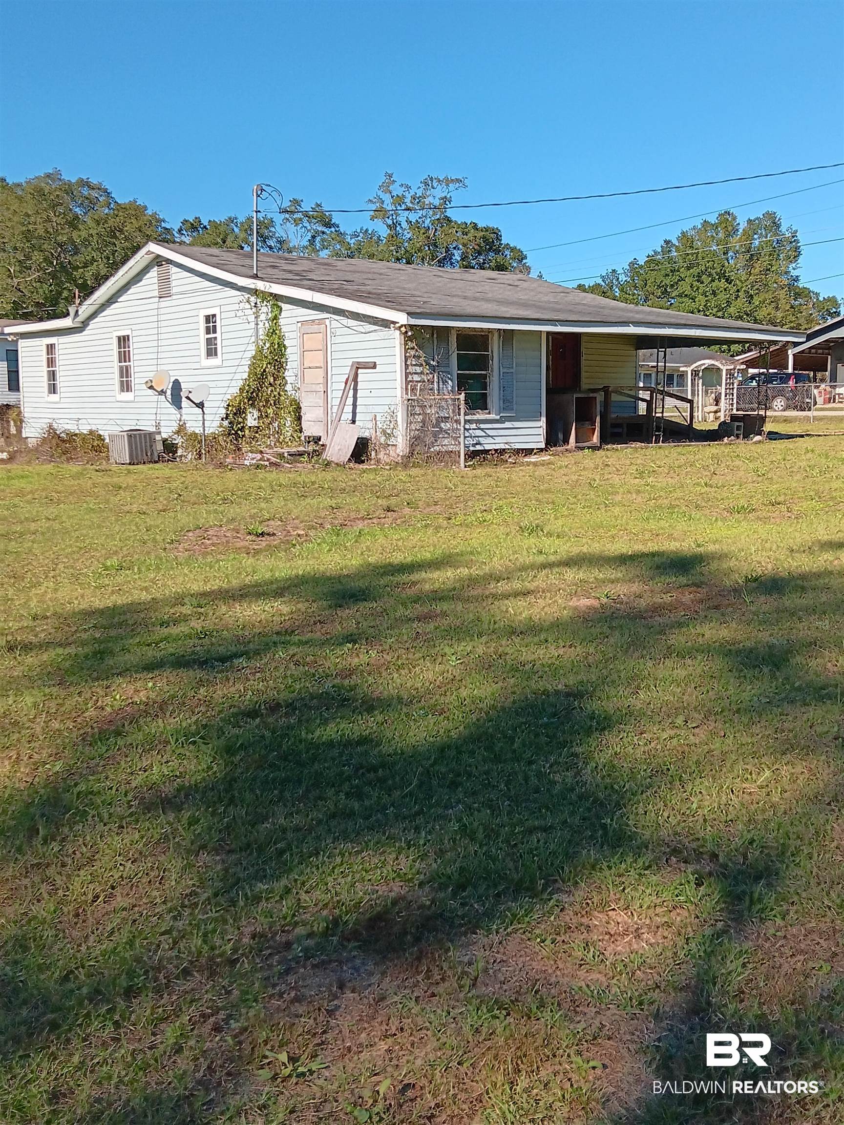 61 Katherine Street Flomaton, AL 36441 - Photo 2 of 13 View of front of house with a carport and a front lawn