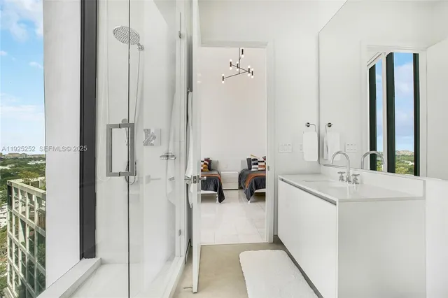 a en suite bathroom with a sink a mirror and shower