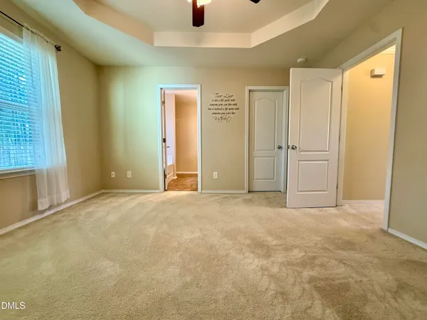 an empty room with windows and closet