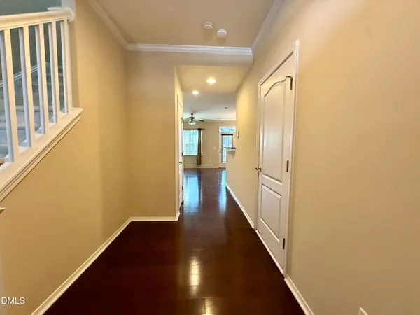 a view of a hallway with wooden floor