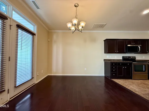 a view of a kitchen with wooden floor and a ceiling fan