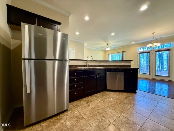 a kitchen with a refrigerator and a sink