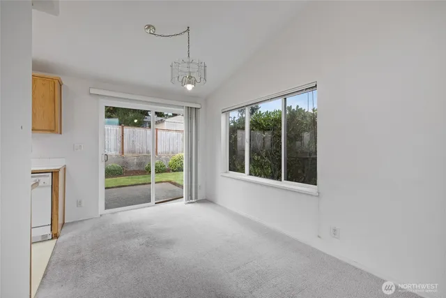 a view of an empty room with glass door and balcony