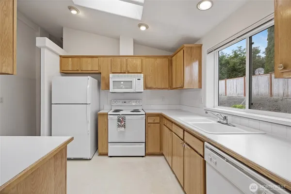 a kitchen with a sink stove and refrigerator