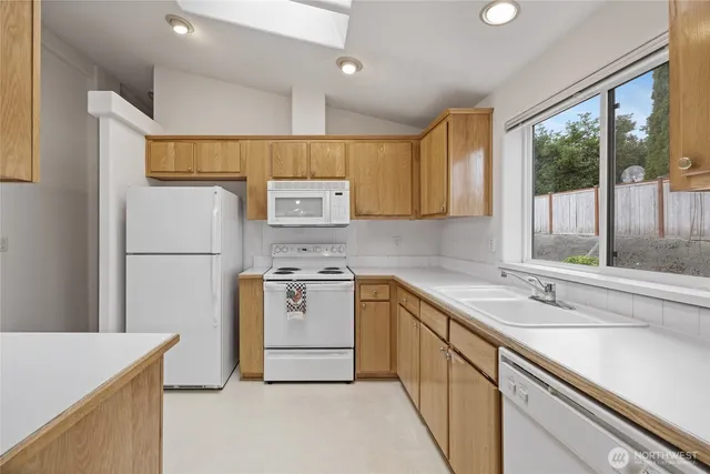 a kitchen with a sink stove and refrigerator