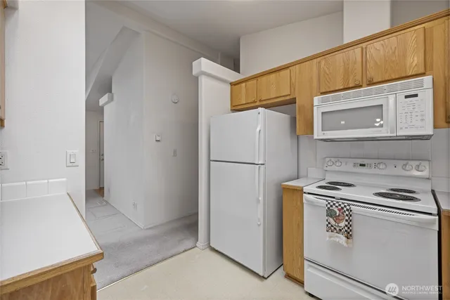 a kitchen with a refrigerator sink stove and cabinets