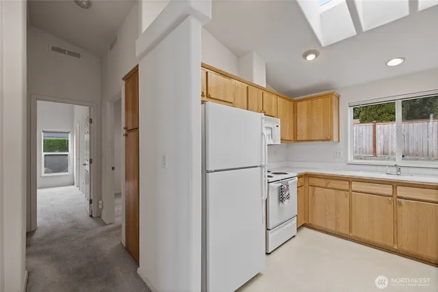 a white refrigerator freezer sitting inside of a kitchen