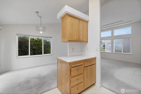 a kitchen with a stove a sink and a window