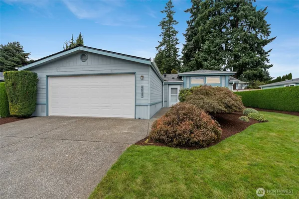 a view of a house with a yard and garage