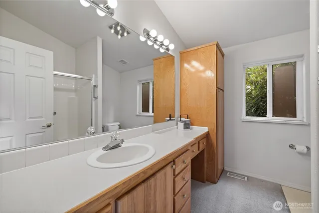 a bathroom with a sink double vanity and a mirror