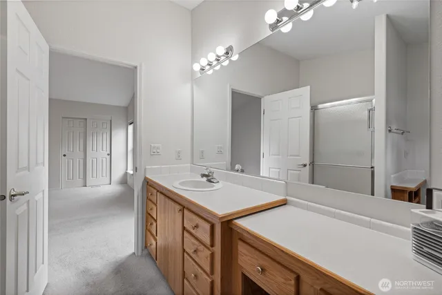 a bathroom with a sink double vanity and a mirror