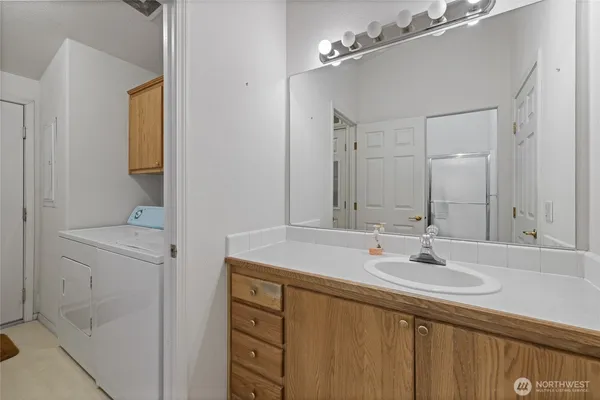 a bathroom with a sink vanity and mirror