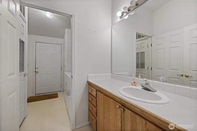 a bathroom with a sink a vanity and a mirror
