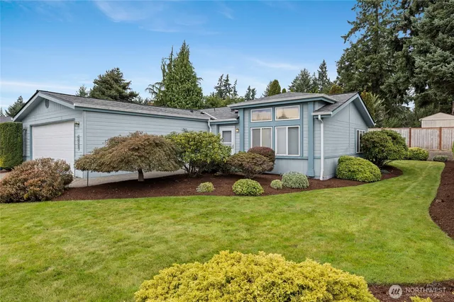 a view of a house with a yard and plants