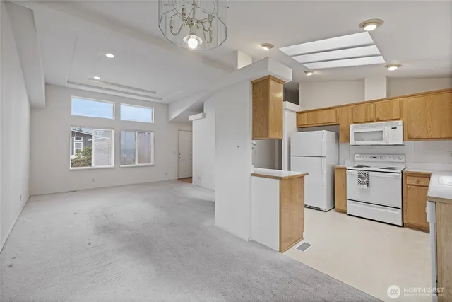 a view of a kitchen with refrigerator and microwave