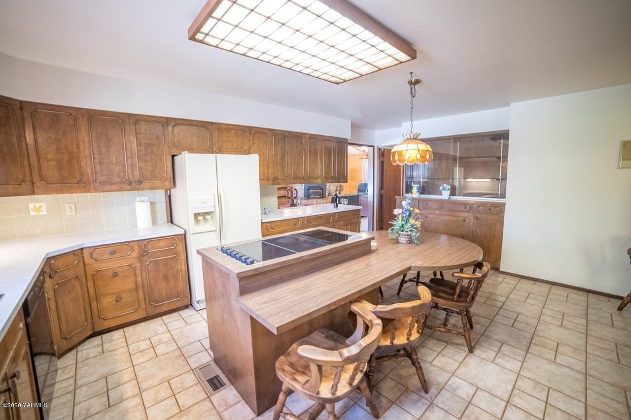 8540-2 Fort Road Wapato, WA 98951 - Photo 37 of 55 a kitchen with granite countertop a stove a sink and a refrigerator