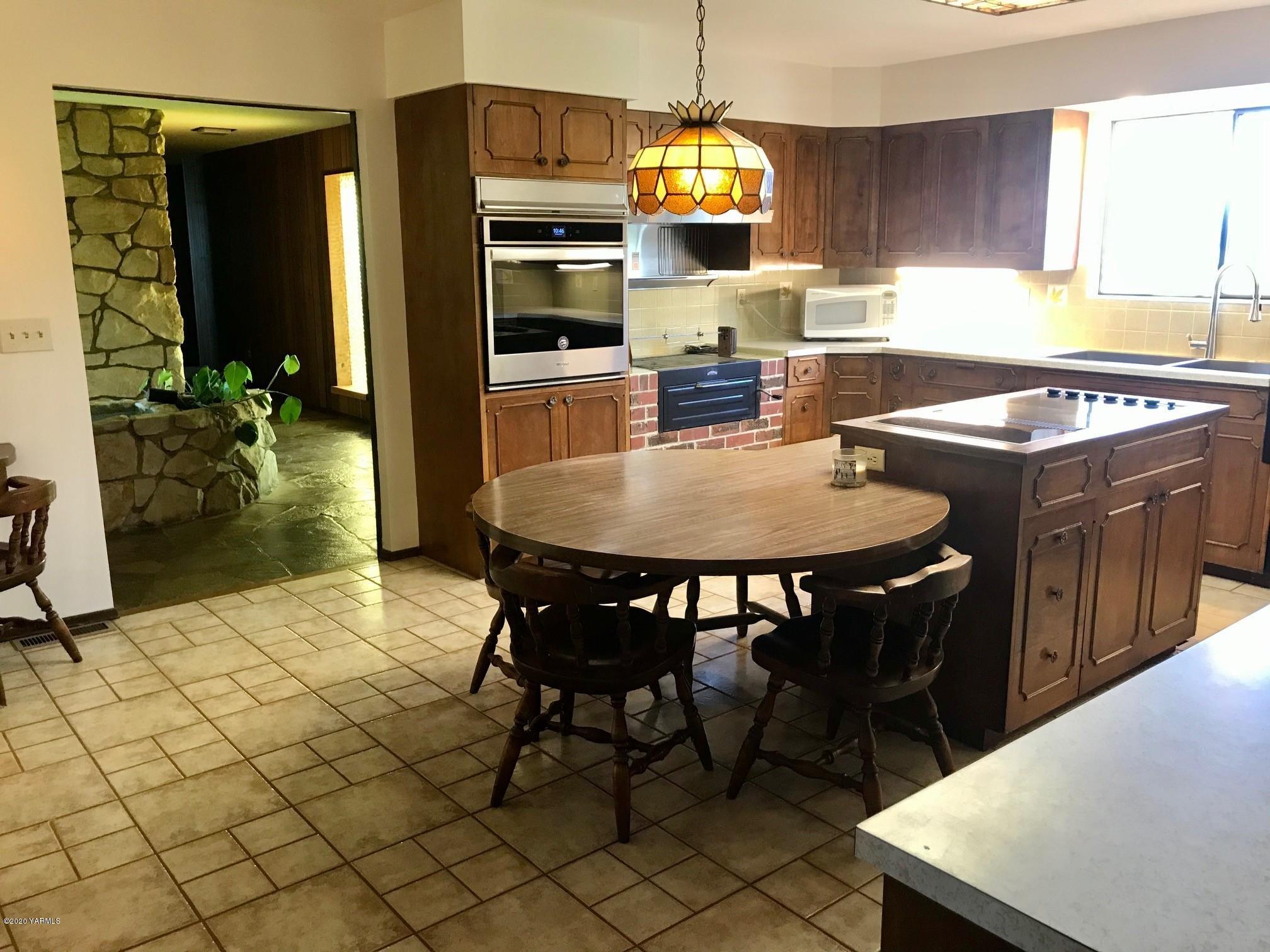 8540-2 Fort Road Wapato, WA 98951 - Photo 5 of 55 a kitchen with a dining table chairs and refrigerator