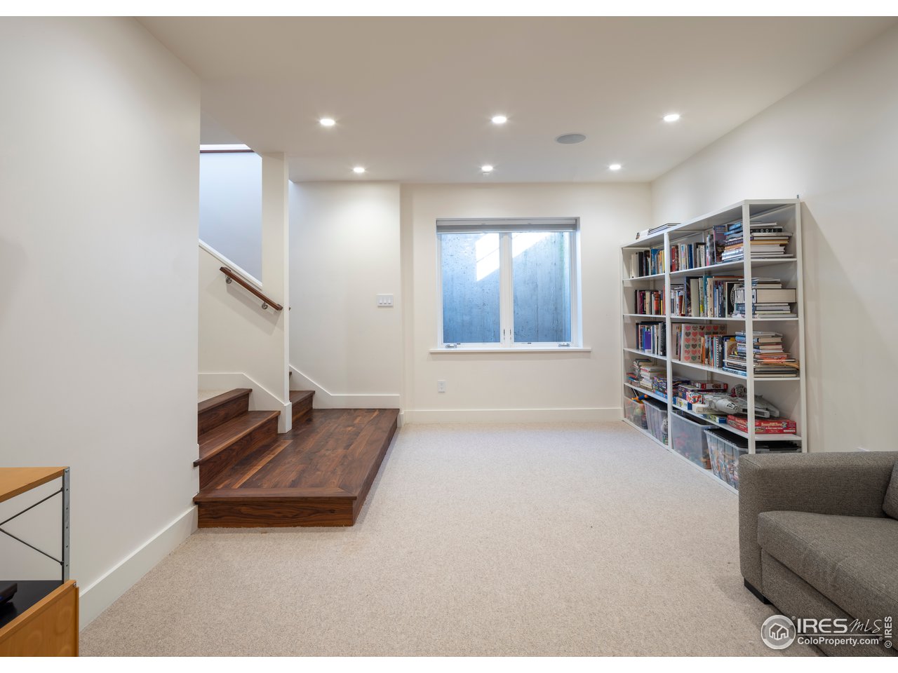704 Concord Avenue Boulder, CO 80304 - Photo 25 of 27 a living room with furniture and a book shelf