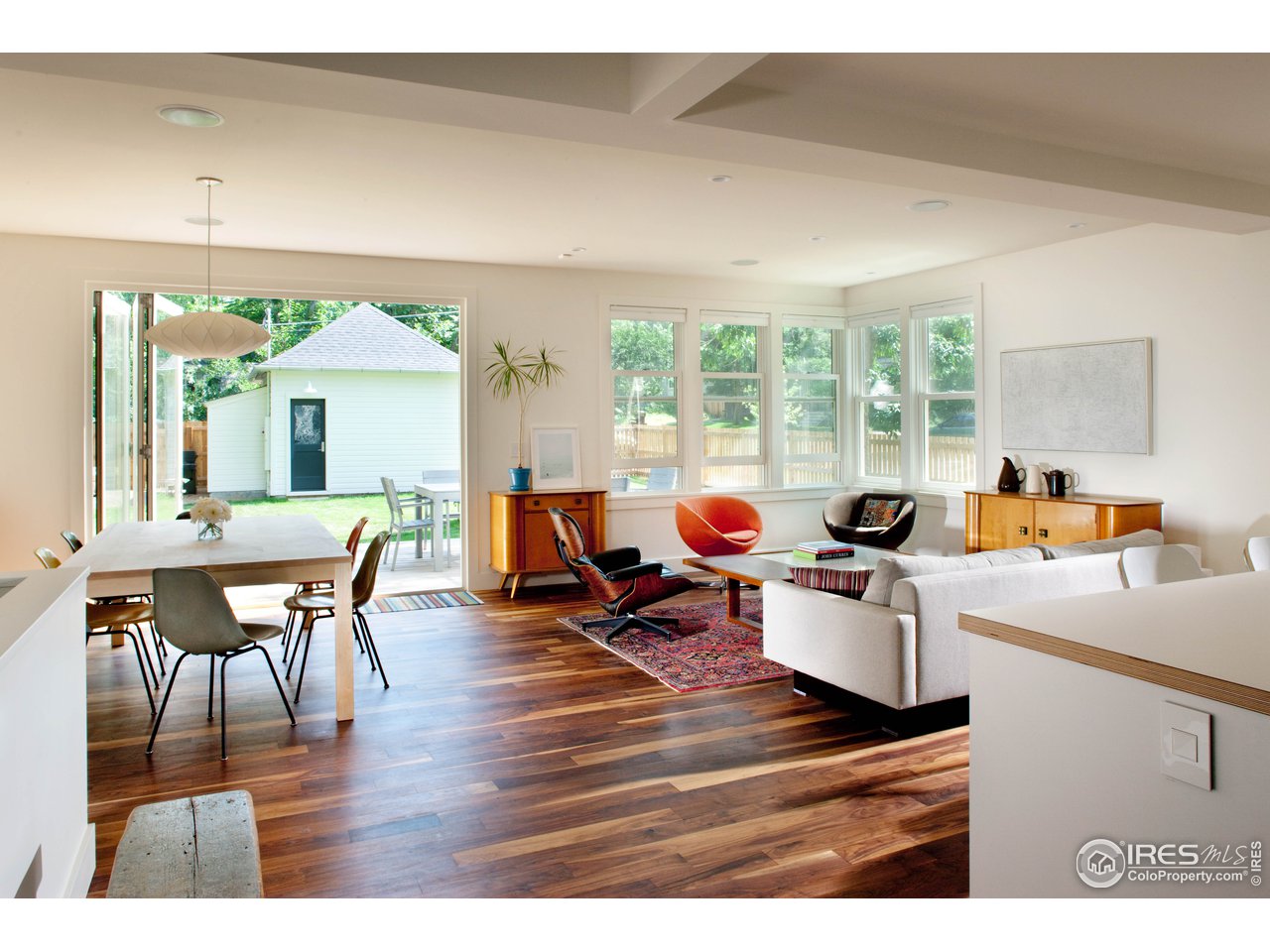 704 Concord Avenue Boulder, CO 80304 - Photo 6 of 27 a living room with furniture a wooden floor and a large window