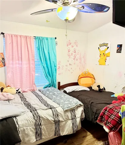 a bedroom with a bed and a painting on the wall