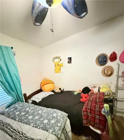 a bedroom with a bed and a large mirror on the dresser