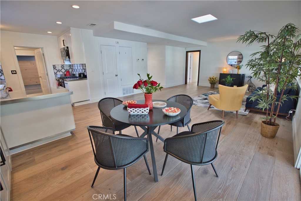 6091 Dundee Drive Huntington Beach, CA 92647 - Photo 14 of 55 a view of a dining room with furniture and wooden floor